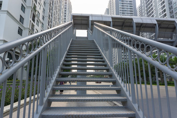Steel stair step to walk up or walk down to the outdoor public bridge