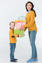 smiling mother and son with wrapped gifts looking at camera isolated on white