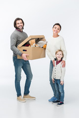 Fototapeta na wymiar Happy father holding cardboard box with toys and looking at camera isolated on white