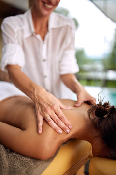 Close up of woman receiving back massage at salon spa.