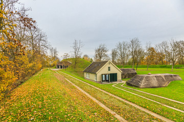 Earthen fortifications with concrete bunkers and wooden storage shed in Werk aan 't Spoel a fortress of the Nieuwe Hollandse Waterlinie