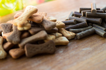Dog tasty colored biscuits on wooden background, snacks for dogs
