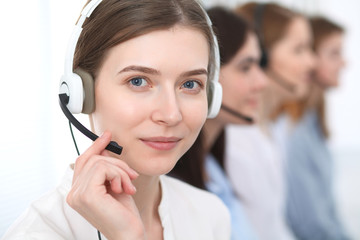 Call center. Beautiful cheerful smiling operator consulting clients with headset. Business concept of customer service