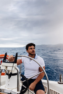Captain of a ship sailing on a sailboat