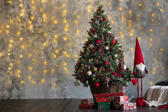 Christmas tree decorated by garlands and lights. Copy space