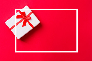christmas gift on red background with frame. Copyspace