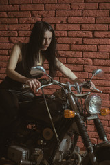 Fototapeta na wymiar backstreet. backstreet girl on motorbike. girl biker on motorcycle in backstreet. backstreet woman biker