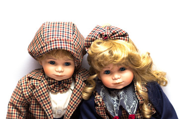 Two ceramic gardeners dolls sitting on white background.