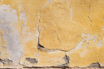 Cracking paint on an old concrete wall