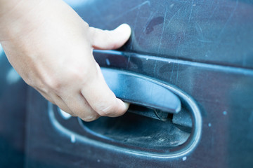 Hand on handle.Close up of woman hand opening a vintage car door.