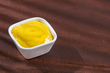 Mustard sauce in the bowl - Top view
