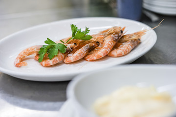 A few shrimps nicely decorated on white plate