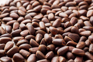 Background of pine nuts. Selective focus. Copy space