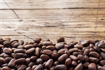 Pine nuts on a wooden background. Selective focus. Copy space