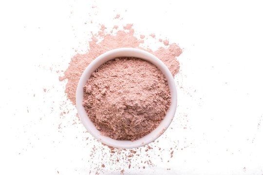 Dry Pink Clay Powder Mask For Face And Body  In Ceramic Bowl Isolated On White