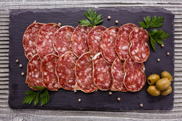 Saucisson sec delicious french salami on a wooden background