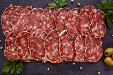 Saucisson sec delicious french salami on a wooden background