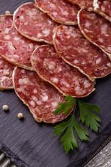 Saucisson sec delicious french salami on a wooden background