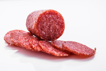 delicious sliced salami on a white background