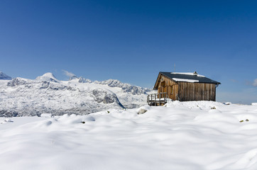 Dachstein, Salzkammergut, Austria; September 4, 2017:  Mountain chalet  in the Austrian Alps on Krippenstein with a view to a Dachstein top after sudden snowfall.