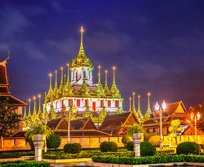 Metal Castle or Wat Ratchanadaram Worawiharn at night in Bangkok, Thailand, The temple is the only metallic castle in Thailand © kardd