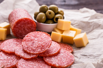 delicious sliced salami on a wooden background