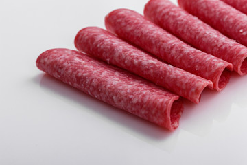 delicious sliced salami on a white background