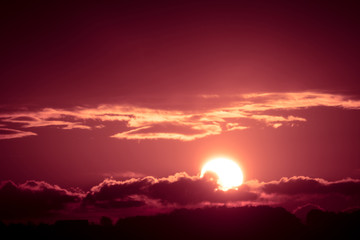 Bright big sun on the sky with clouds