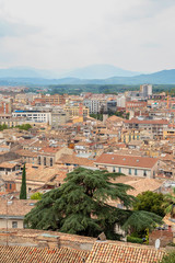 Fototapeta na wymiar roofs of Girona on the background of the mountains