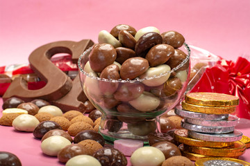 St.Nicholas day in December, children holiday in Netherlands, Belgium, Germany and Curacao, chocolate spicy ginger cookies, letters and coins on pink background copy space