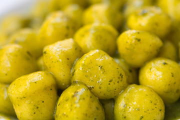 Homemade handmade Italian potato gnocchi pasta with basil pesto sauce