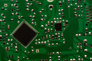 Microelectronics hardware concept. Industry, computing. The back side of the PCB with chip. 