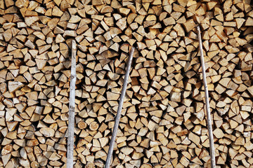 Chopped wood laid in a woodpile to dry for the winter. Wood texture.