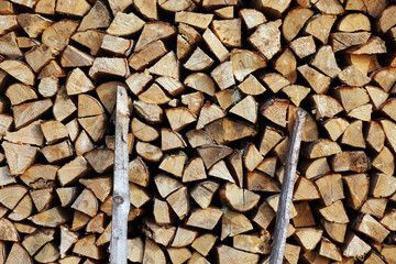 Chopped wood laid in a woodpile to dry for the winter. Wood texture.