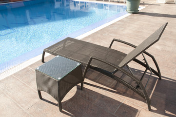 patio sunbed by the blue swimming pool