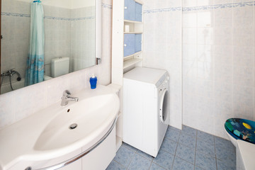 Fototapeta na wymiar Vintage bathroom with tiles and washing machine