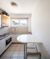 Vintage kitchen with stools and window on the hills