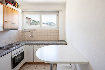 Vintage kitchen with stools and window on the hills