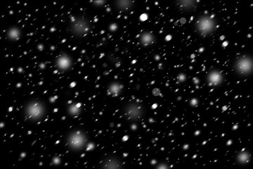 Snowstorm texture. Bokeh lights on black background, shot of flying snowflakes in the air