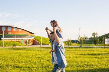 Fatherhood, family and children concept - Father and daughter having fun and playing in nature.