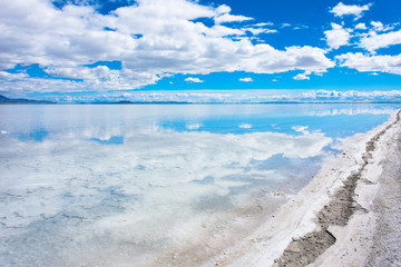 Flooded Bonneville Salt Flats in Utah create a mirror reflection scene on the water, looking surreal