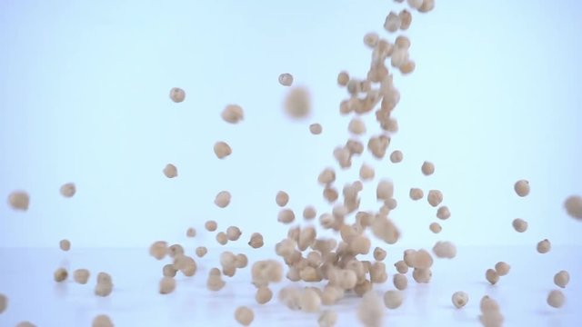 Peas falling in slow motion (10x speed).