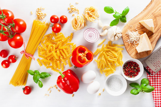 ingredients for italian cousine flat lay, pasta spaghetti penne fusilli tomato oil vegetables