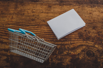 empty shopping basket with copyspace on memo paper