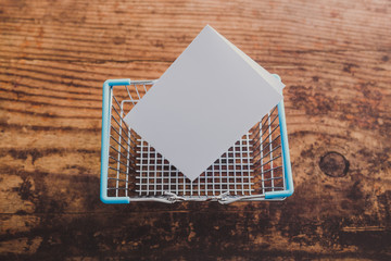 empty shopping basket with copyspace on memo paper