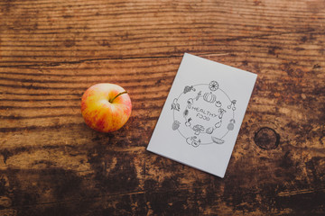 apple and healthy food note on memo paper on wooden table,