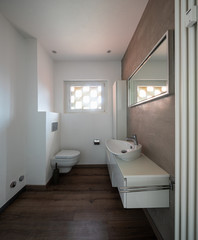 Modern minimal bathroom with parquet
