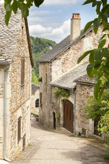 Village street with ancient walls and houses in village of Najac, Aveyron, France