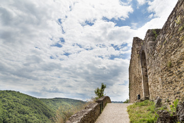 Castle of Najac on a hilltop in the Aveyron, France - external wall and path