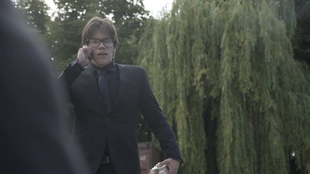 Man walks with tray of eggs, talks on phone and suddenly sees the gangster